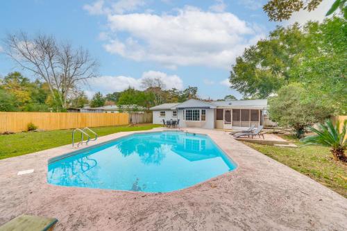 a swimming pool in the backyard of a home at Foosball Games and Al Fresco Dining Pensacola Home! in Pensacola