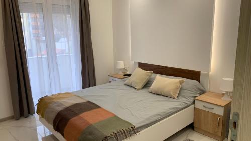 a bedroom with a bed with two pillows on it at Jevtic in Vračar (historical)