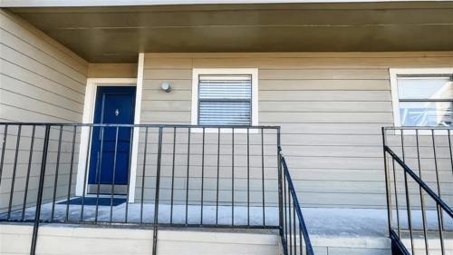 a front porch of a house with a blue door at 10 Min to Downtown - Pet-friendly, TV with Parking in Robstown
