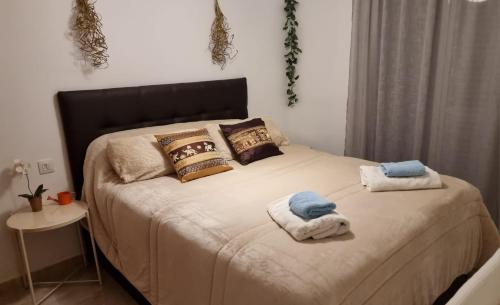 a bedroom with a bed with towels on it at Apartamento Altea Centro in Altea