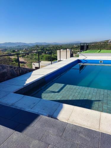a swimming pool on top of a house at Vista Encantada Complejo in Villa Carlos Paz