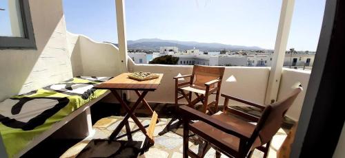 a balcony with a table and two chairs and a window at Haus Sifnaios in Andiparos