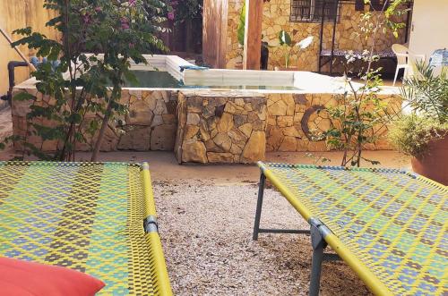 two benches sitting in front of a bath tub at Campement Baobab in Poponguine