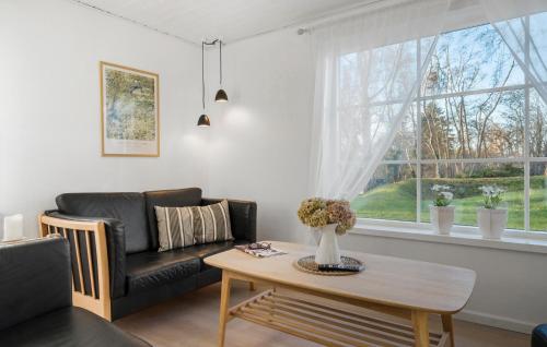 a living room with a couch and a table at Awesome Home In Korsør With Wifi in Korsør