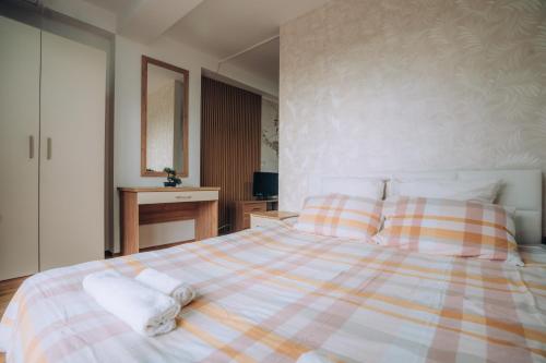 Ένα ή περισσότερα κρεβάτια σε δωμάτιο στο SANA Apartments