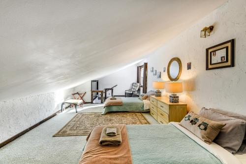 a large room with two beds and a mirror at 11 Mi to Sugarbush Eclectic Ski House with Hot Tub! in Roxbury