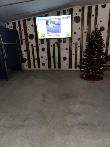 a christmas tree in a room with a television at MONADIN Villa Relax & Spa in Săcele