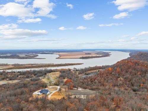 an aerial view of a river with trees and buildings at Paradise Point Rover River View in Muskogee