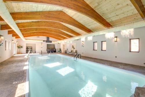 a large swimming pool with a wooden ceiling at Game Room, Media Room and Pool Luxe Villa in Craig! in Craig