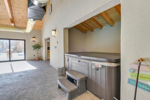 a kitchen with a counter and a stool in a room at Game Room, Media Room and Pool Luxe Villa in Craig! in Craig