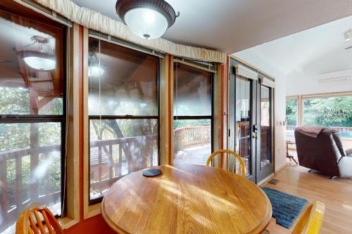 a wooden table in a room with a large window at Julie's Cabin in Carpenterville