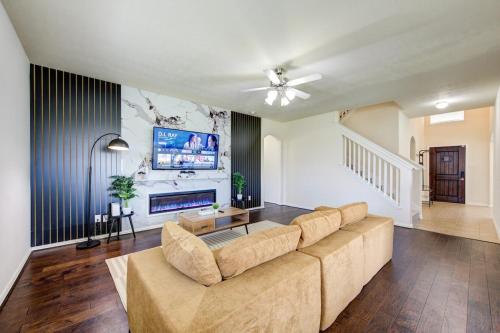a living room with a couch and a tv at Elegant Retreat at Katy Houston, 2330 sf, 4 Bedroom 2 and Half Baths, Game Room, King Bed, BBQ, Located near Katy Asian Town, Typhoon Waterpark in Katy