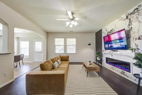 a living room with a couch and a flat screen tv at Elegant Retreat at Katy Houston, 2330 sf, 4 Bedroom 2 and Half Baths, Game Room, King Bed, BBQ, Located near Katy Asian Town, Typhoon Waterpark in Katy