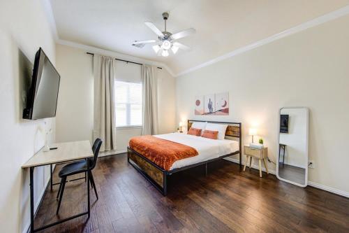 a bedroom with a bed and a desk and a television at Elegant Retreat at Katy Houston, 2330 sf, 4 Bedroom 2 and Half Baths, Game Room, King Bed, BBQ, Located near Katy Asian Town, Typhoon Waterpark in Katy
