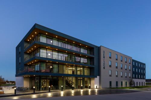 a large building with a lot of windows at Denizen Hotel in McKinney