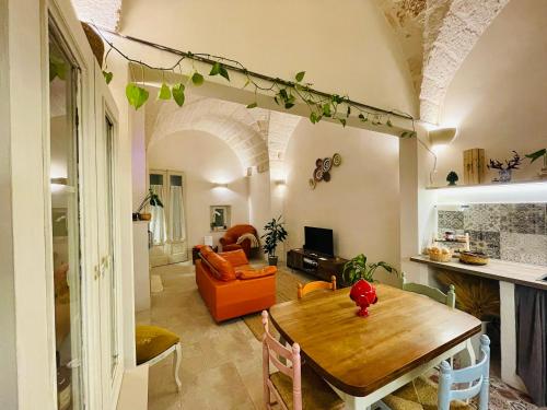 a living room with a wooden table and a couch at Al Palazzotto in Fasano
