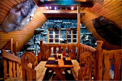 a wooden table and chairs in a room at Hotel Viking in Hafnarfjördur