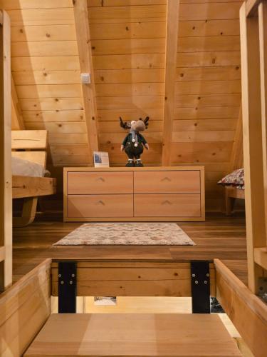 a room in a cabin with a cow on a dresser at Vikendica Villa Marija Pale in Pale