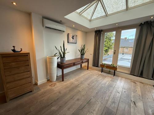 a living room with a skylight and a desk and a window at Stylish 1-Bedroom Apartment in Eindhoven in Eindhoven
