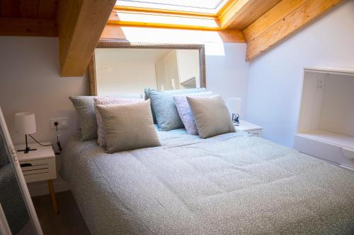 a bedroom with a bed with a large mirror at Via de la Plata Luxury Suites B in La Bañeza