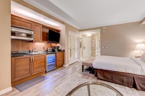 a large bedroom with a bed and a kitchen at Luxury Studio MGM Signature Best Location Lazy River No Resort Fee in Las Vegas
