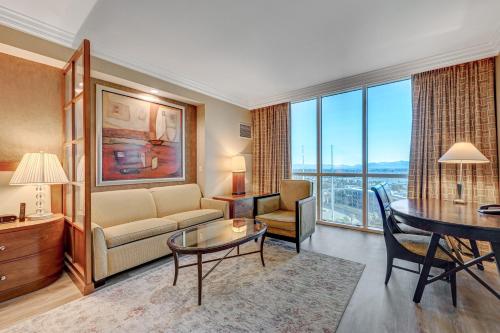 a living room with a couch and a table at Luxury Studio MGM Signature Best Location Lazy River No Resort Fee in Las Vegas