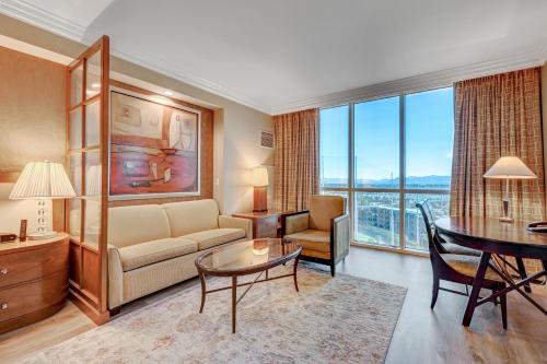 a living room with a couch and a table at Luxury Studio MGM Signature Best Location Lazy River No Resort Fee in Las Vegas