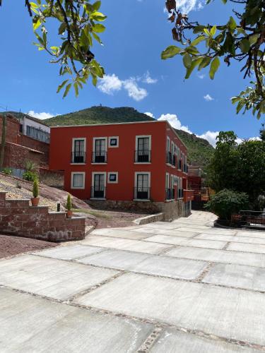 a red building with a grass roof at Quinta Mercedes in Guanajuato