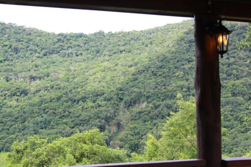 a view from a window of a mountain at Pousada Vila Felicita in São Valentim