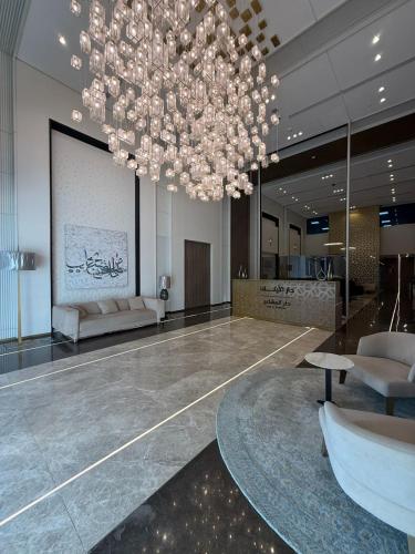 a large lobby with a large chandelier in a building at دار المشاعر in Makkah