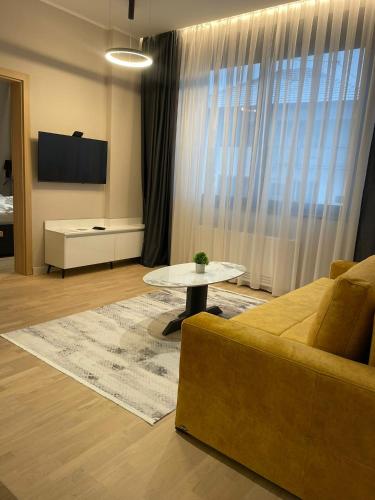 a living room with a couch and a table at Moaline Apartments, free parking in Sarajevo