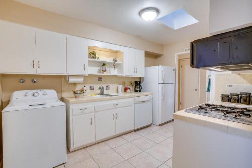 a kitchen with white cabinets and a white refrigerator at Patio and Yard Sun City Home Near Casinos in Sun City