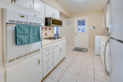 a kitchen with white appliances and a refrigerator at Patio and Yard Sun City Home Near Casinos in Sun City