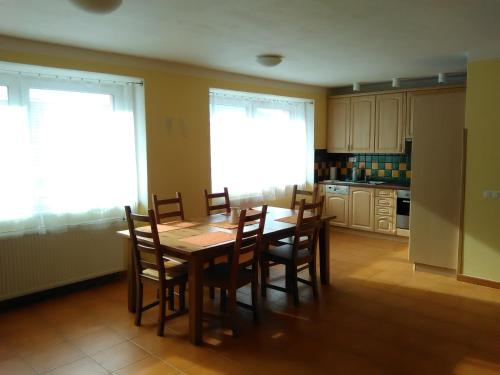 a kitchen with a dining room table and chairs at Agroturistika kozí farma Rožnov pod Radhoštěm in Rožnov pod Radhoštěm