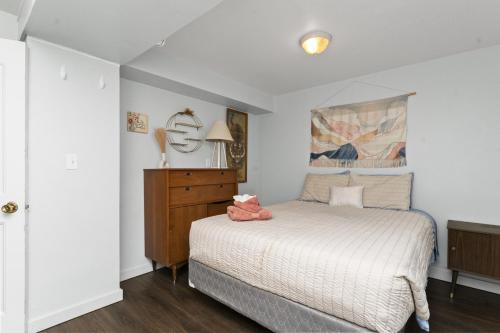 グレートフォールズにあるCharming 2-Bedroom Apartmentのベッドルーム1室(ベッド1台、ドレッサー、ランプ付)