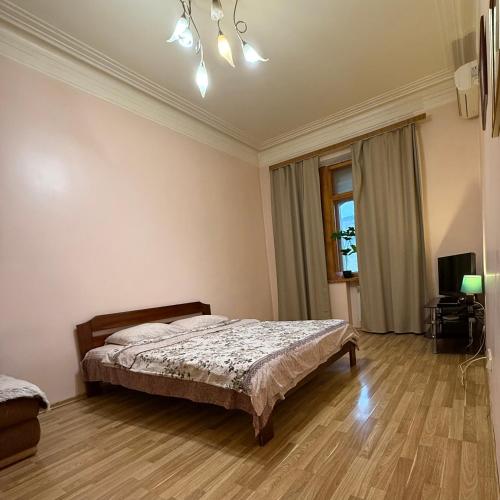 a bedroom with a bed and a television in it at Апартменти на майдані Незалежності in Kyiv