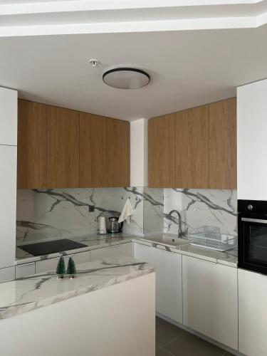 a kitchen with marble counter tops and a sink at Amelie's Apartment 2 in Skopje