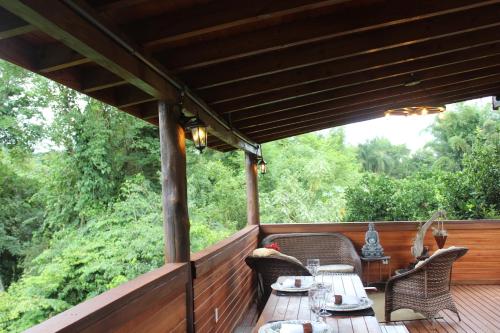 a patio with a table and chairs on a deck at Pousada Vila Felicita in São Valentim