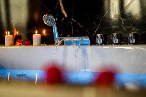 a bathroom sink with water coming out of a faucet at Apartament American Express Rzeszów in Rzeszów