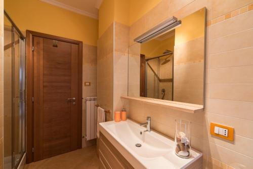 ein Bad mit einem Waschbecken und einem Spiegel in der Unterkunft La Casa di Emma a Trastevere in Rom
