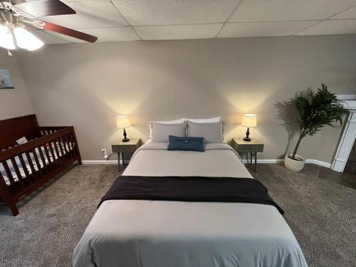 a large bed in a room with two tables and two lamps at Spacious, 4BR Boho - Family & Pet Friendly in Clarksville