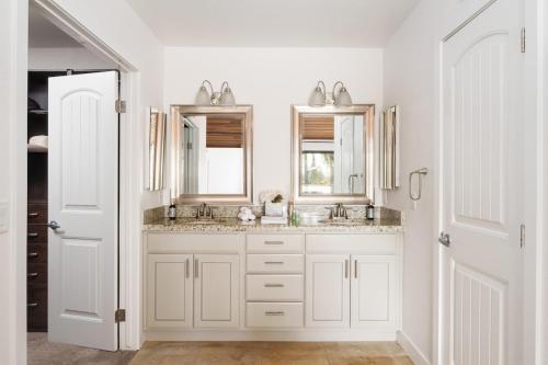 a white bathroom with two sinks and a mirror at Stunning Private Resort with Pool in San Marcos