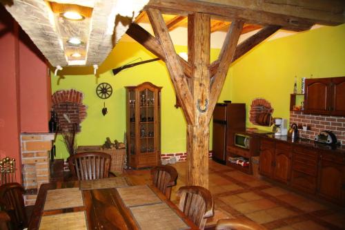 a kitchen with a table and a tree in it at Hrazdeny statek Mytinka in Mýtinka