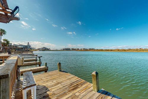 a wooden dock with a view of a lake at Leeward Cove in Padre Island