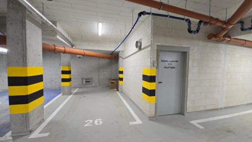 an empty parking garage with yellow and black stripes on the walls at Apartament Dark Prestige NEW ! - dostęp 24h, PROJEKTOR , garaż podziemny , klimatyzacja , duży taras in Kielce