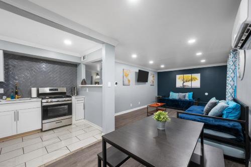 a kitchen and living room with a couch and a table at Chic 2BR Haven in Midtown - Prime Location in Houston