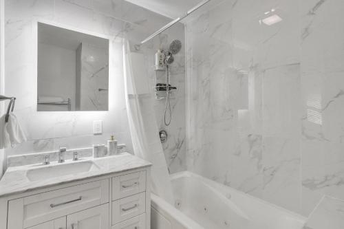 Un baño blanco con lavabo y ducha. en Vibrant Miami Escape with BBQ Grill Free WiFi & Parking, en North Miami Beach