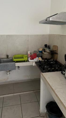 a kitchen with a stove and a counter top at Hotel Albatros Palace - Bungalow G in Manzanillo