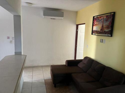 a living room with a couch and a wall at Hotel Albatros Palace - Bungalow G in Manzanillo