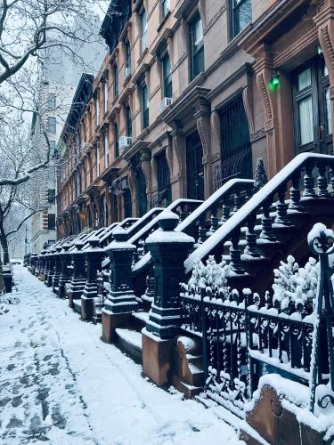 a row of stairs in front of a building in the snow at Harlem Grand in New York